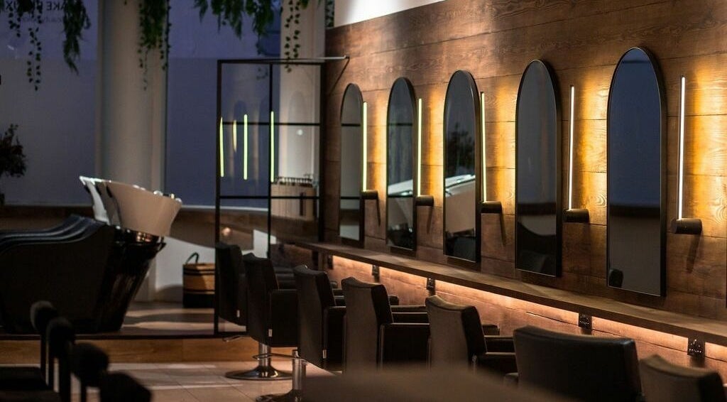 Elegant salon interior at Taylor Cole, Truro, England, GB, featuring stylish mirrors and seating.