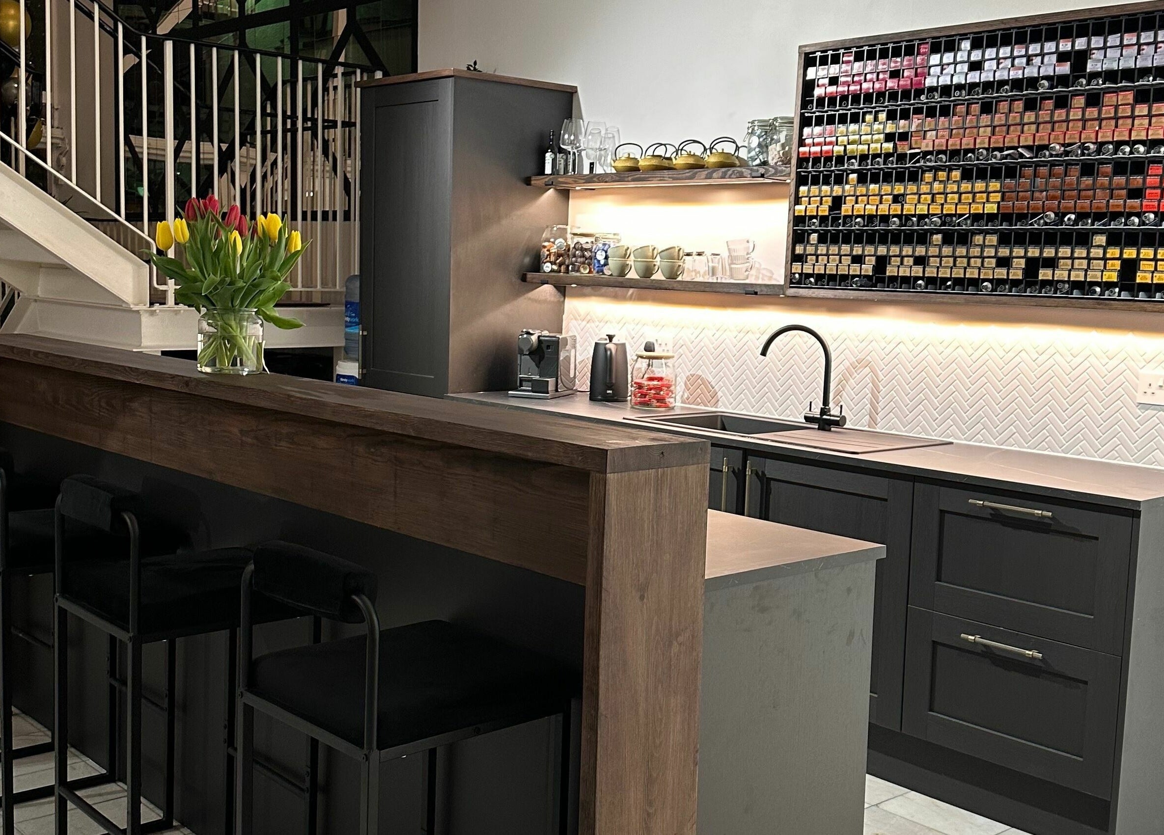 Chic reception bar at Taylor Cole, Truro, England, GB, featuring modern decor and vibrant tulips.