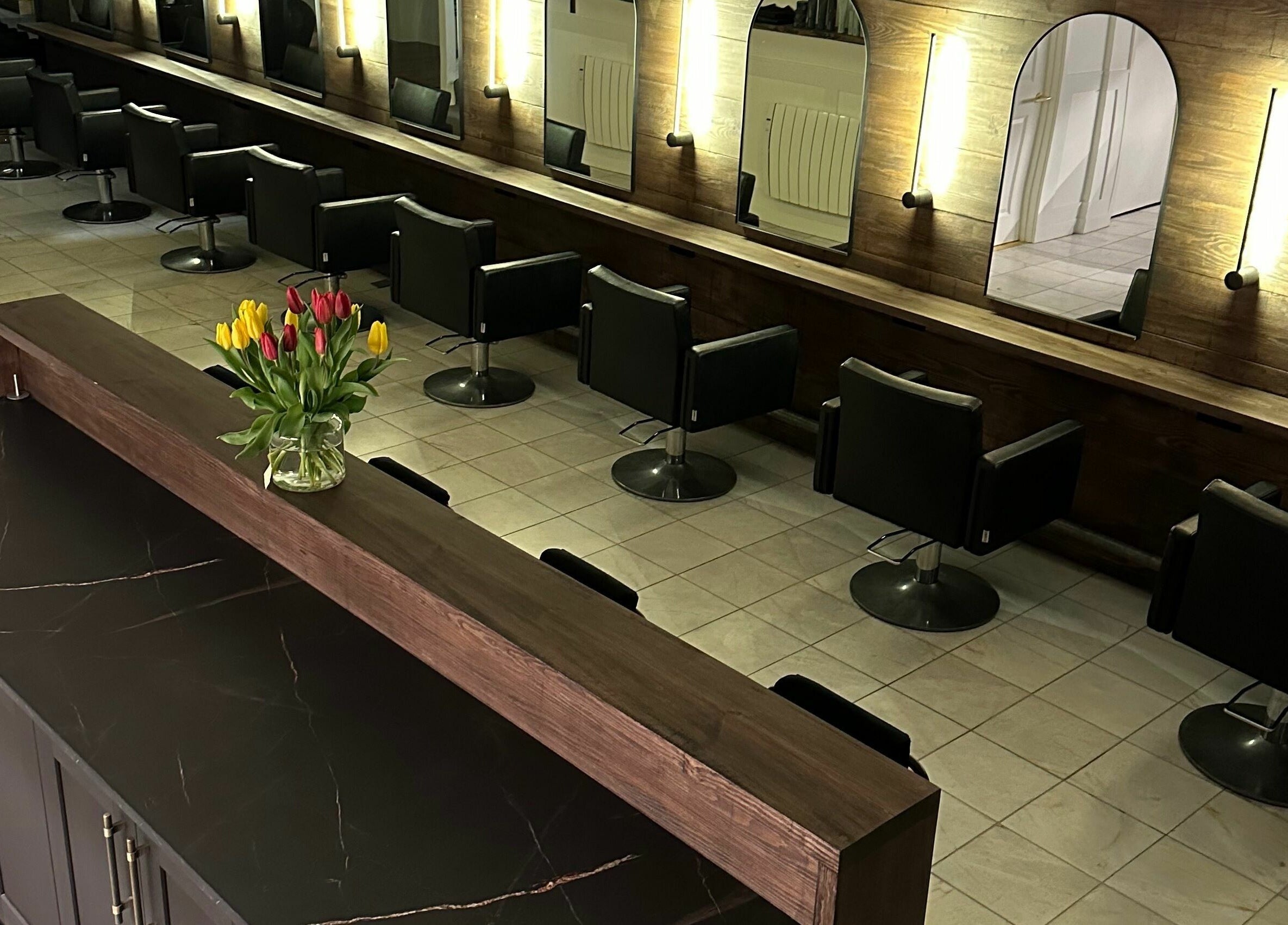 Modern salon chairs and mirrors at Taylor Cole, Truro, England, GB, showcasing elegance and style.