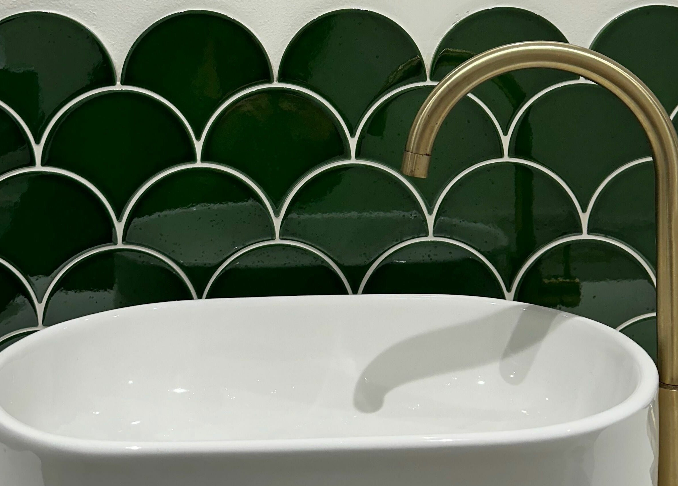 Elegant green tile and brass faucet at Taylor Cole, Truro, England, GB.