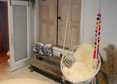 Relaxing nook at Sparrow Beauty Co., Nelson, British Columbia, CA with swing chair and modern decor.