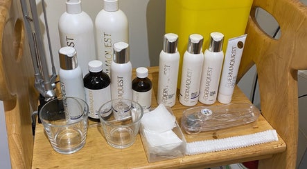 Dermaquest skincare products at Coco Aesthetics & Beauty, Coal Aston, England, GB displayed neatly on a wooden shelf.
