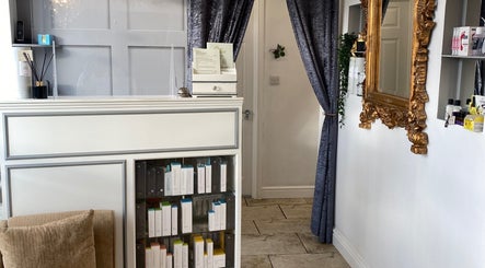 Reception area of Coco Aesthetics & Beauty, Coal Aston, England, showcasing luxurious decor and skincare products.