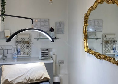 Elegant treatment room at Coco Aesthetics & Beauty in Coal Aston, England, GB featuring a gold ornate mirror.