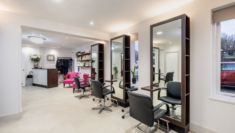 Modern salon interior at Emava, Solihull, England, GB, featuring stylish chairs and mirrors.