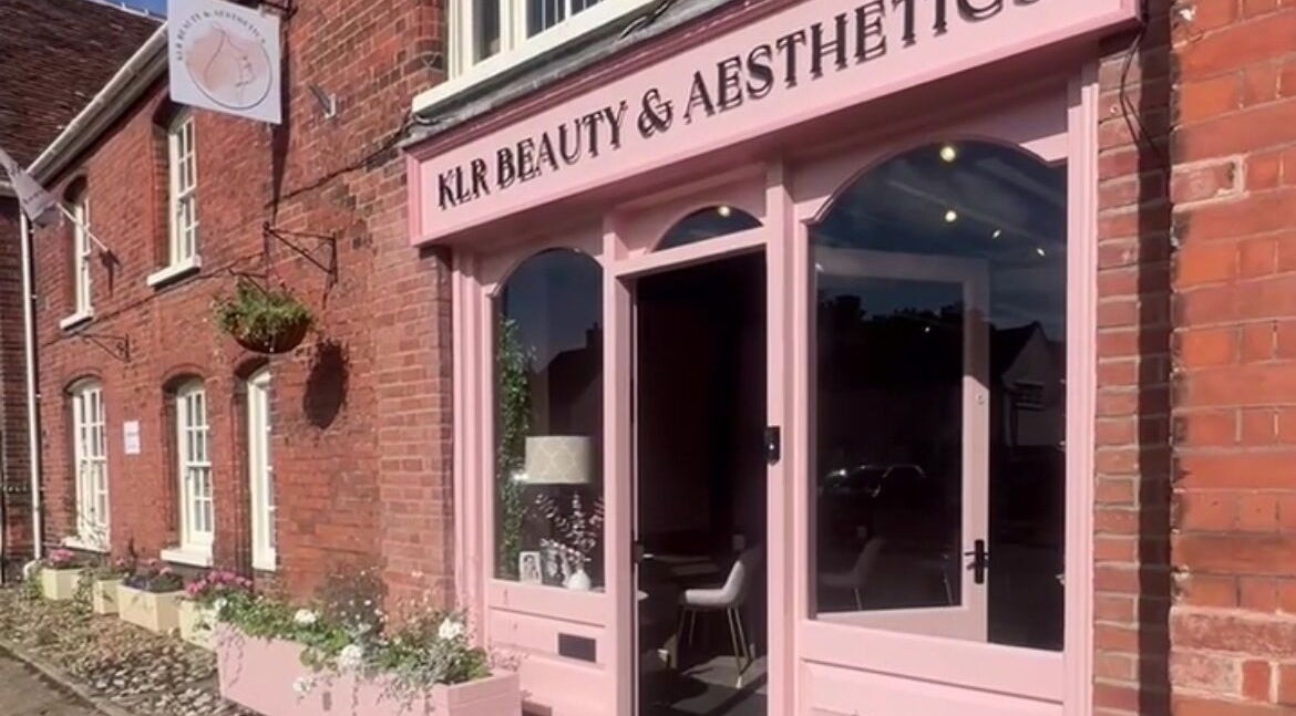 Front of KLR Beauty & Aesthetics, Long Melford, England showcasing elegant pink decor and inviting entrance.