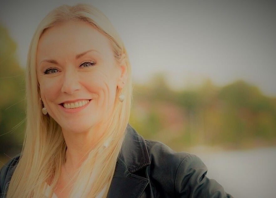 Smiling professional at Symmetry Skin & Body, Greater Sudbury, Ontario, CA, showcasing a welcoming atmosphere.