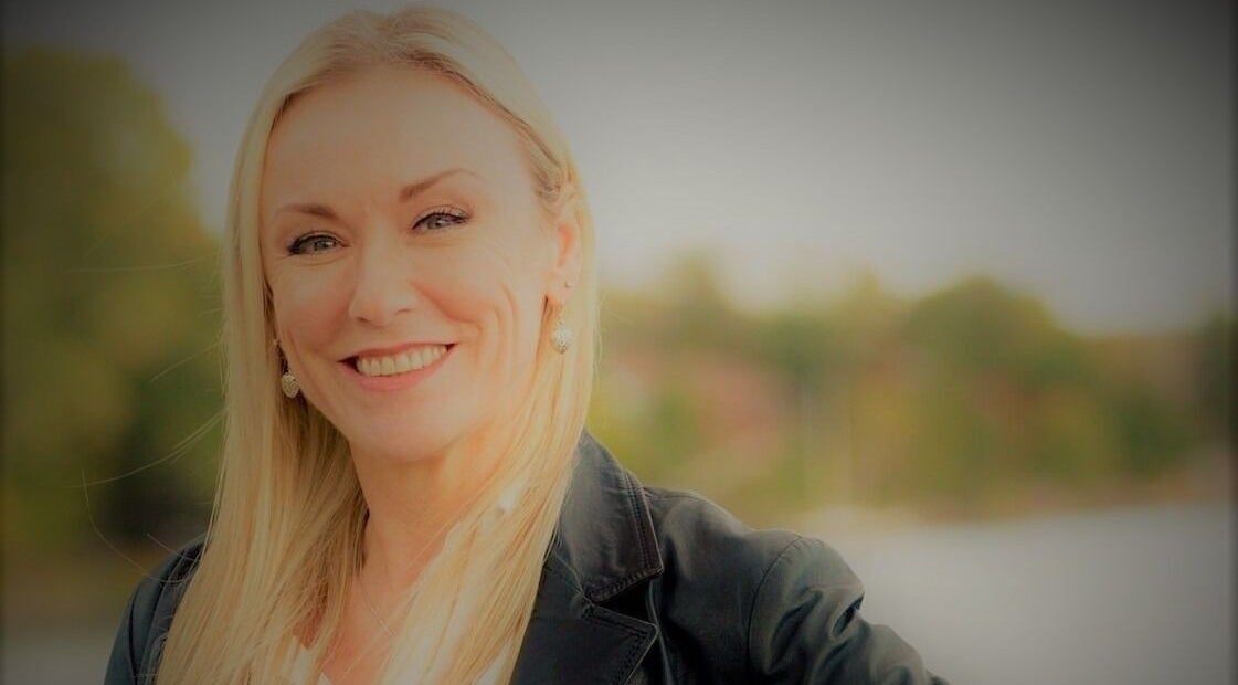 Smiling professional at Symmetry Skin & Body, Greater Sudbury, Ontario, CA, showcasing a welcoming atmosphere.