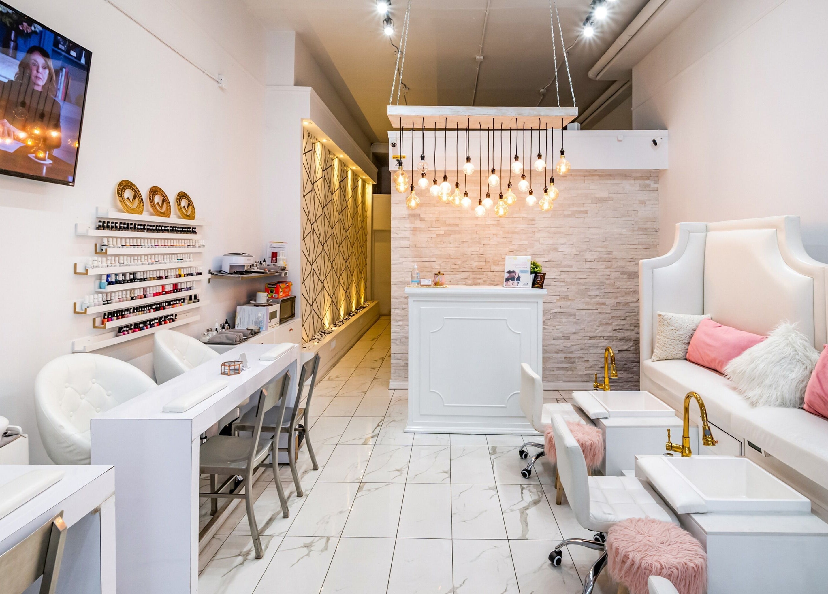 Modern interior of Jade Thread and Wax Bar - Danforth in Toronto, Ontario, CA with stylish decor and white seating.