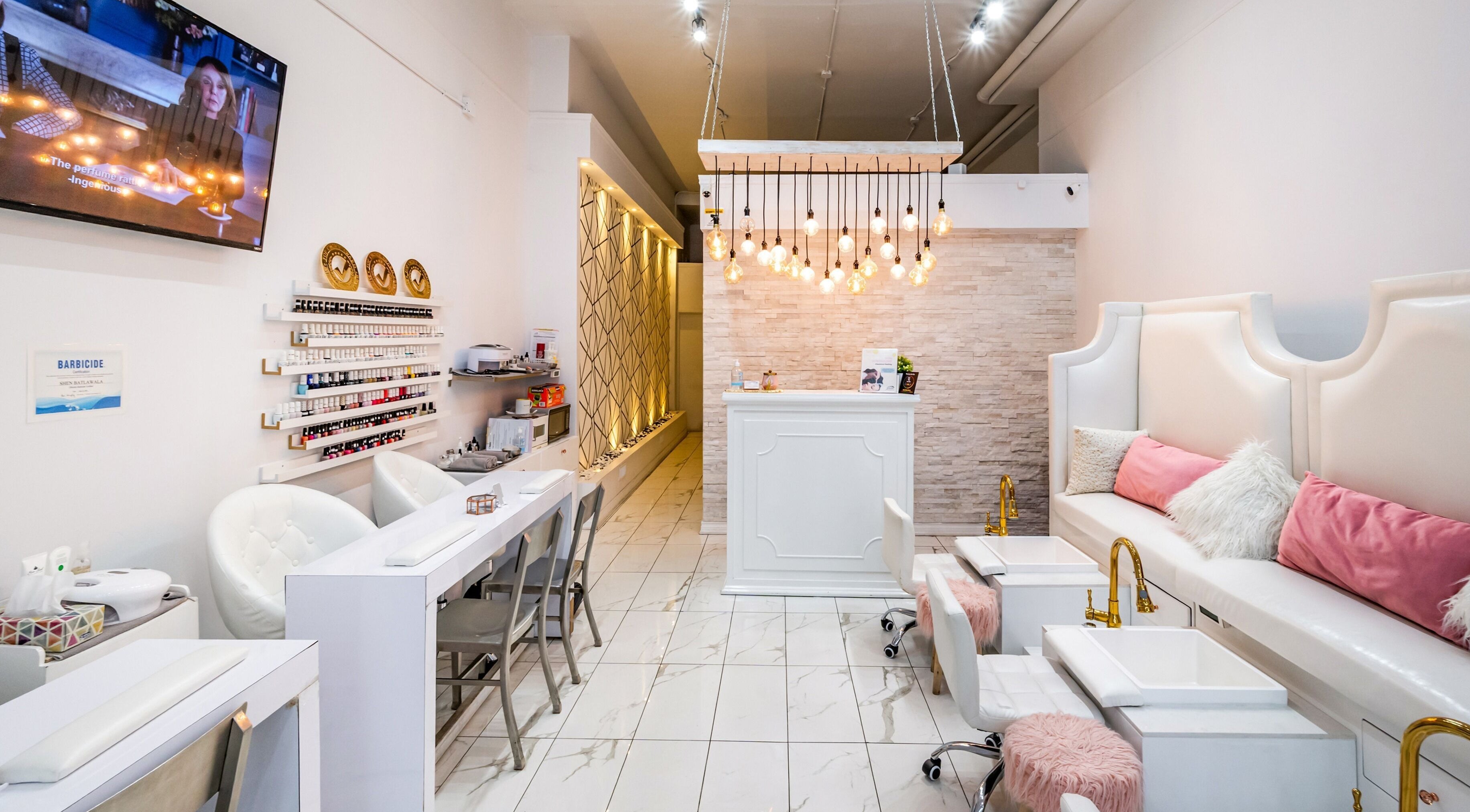 Modern interior of Jade Thread and Wax Bar - Danforth in Toronto, Ontario, CA with stylish decor and white seating.