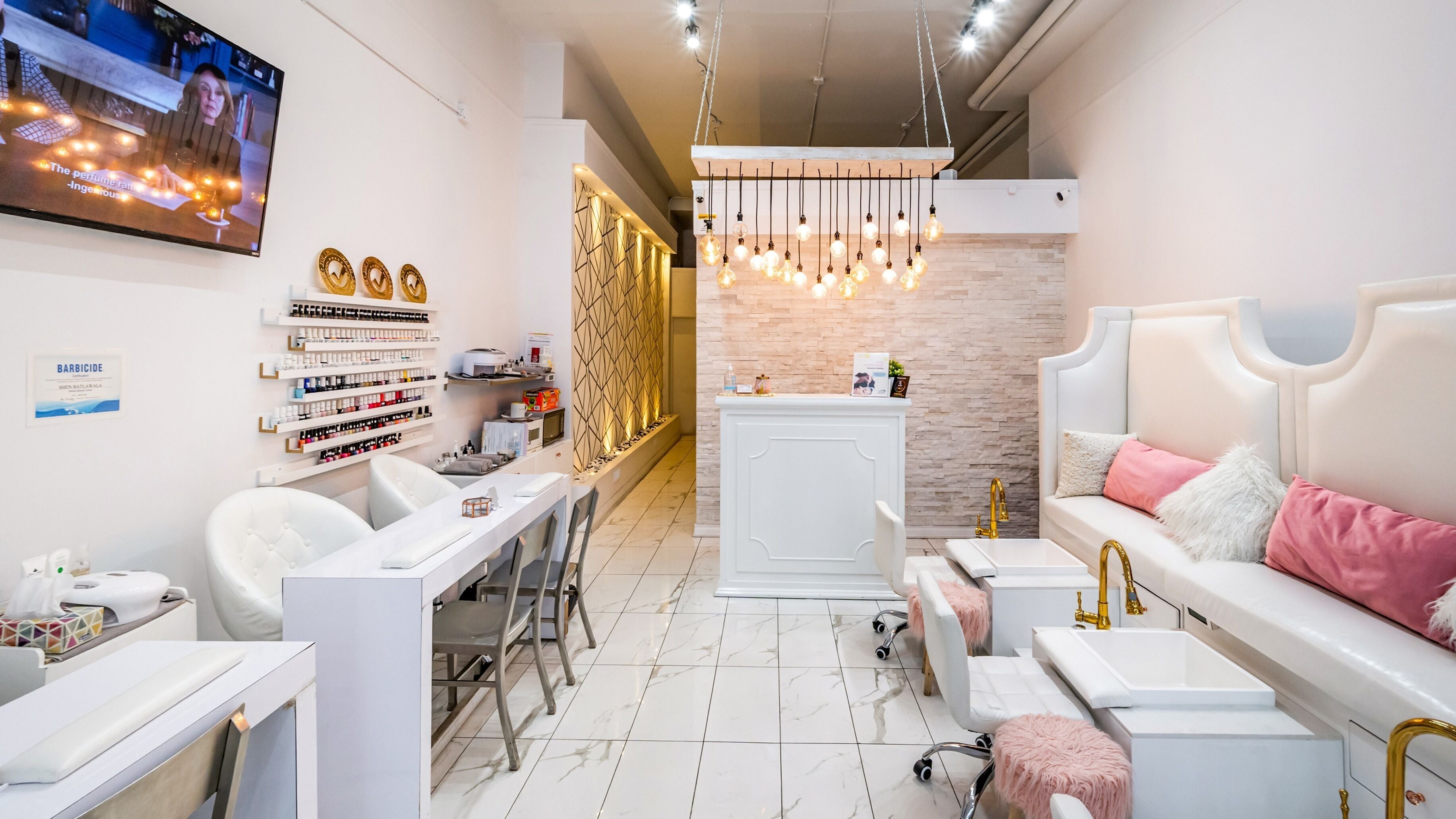 Modern interior of Jade Thread and Wax Bar - Danforth in Toronto, Ontario, CA with stylish decor and white seating.