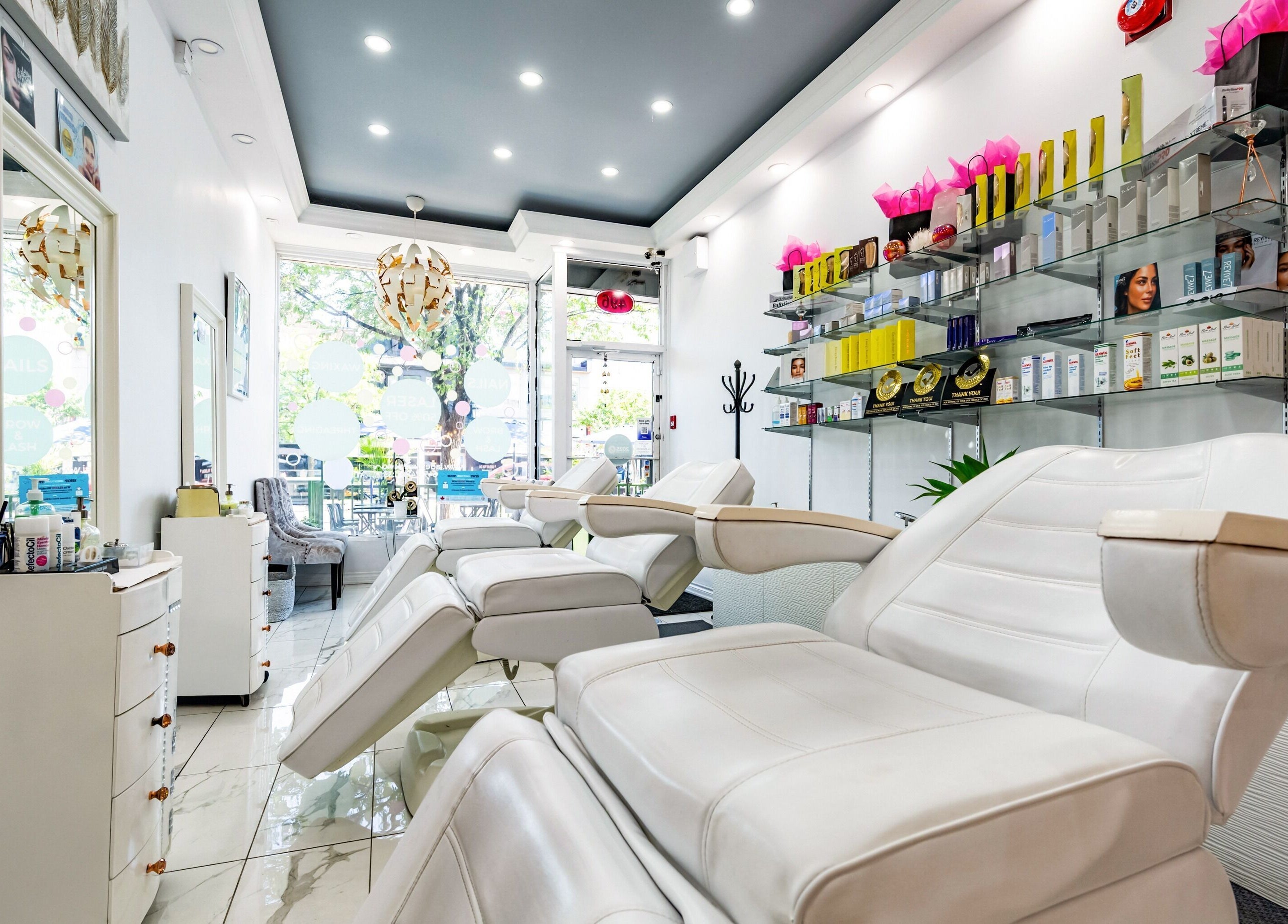Chic spa interiors with white chairs at Jade Thread and Wax Bar - Danforth, Toronto, Ontario, CA.