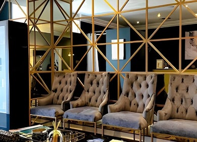 Sophisticated lounge with plush chairs at Body Beautiful Durban, Durban North, KwaZulu-Natal, ZA.