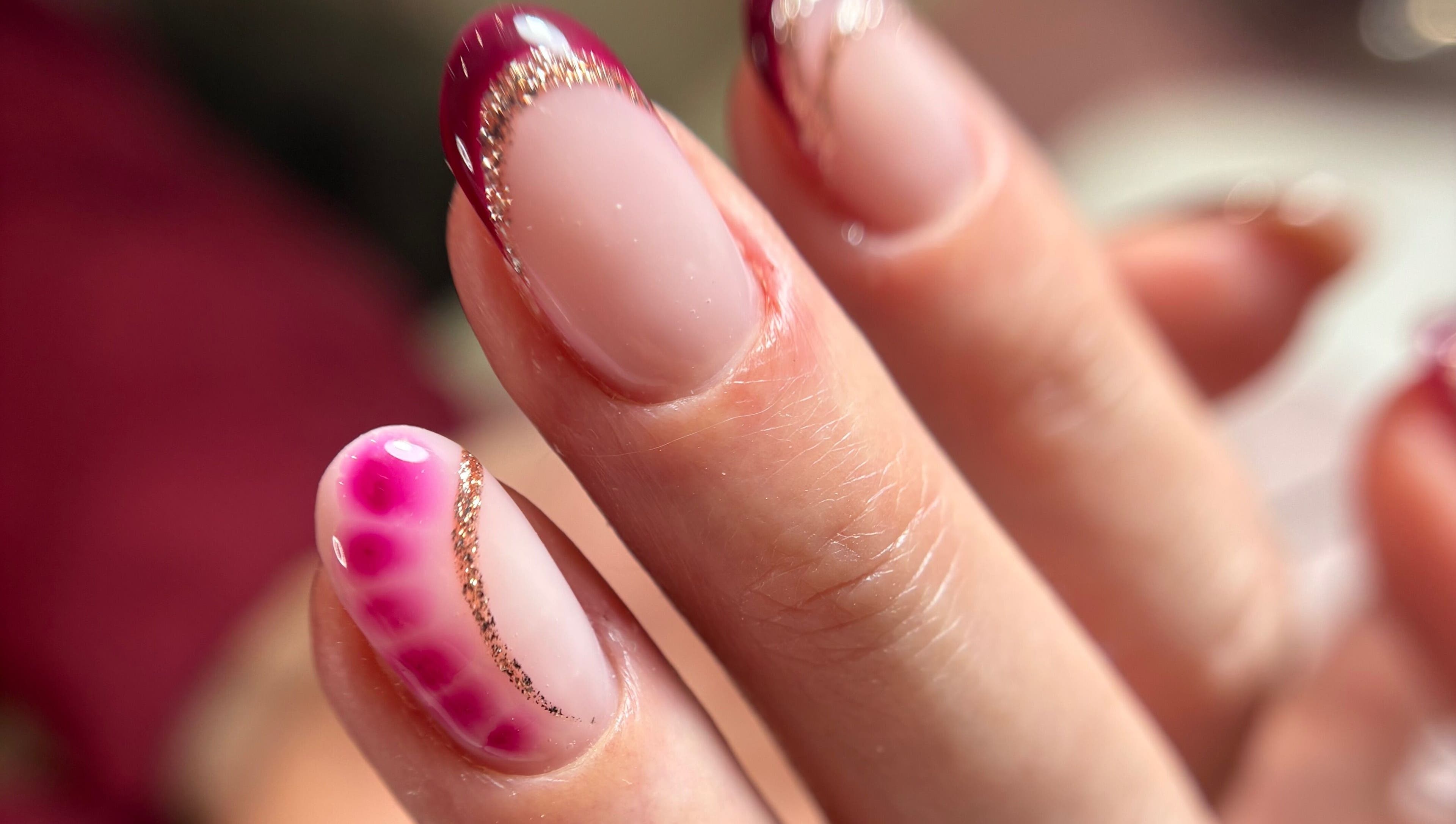 Elegant nail art with gold glitter at Kirsty’s Beauty in Poole, England, GB.