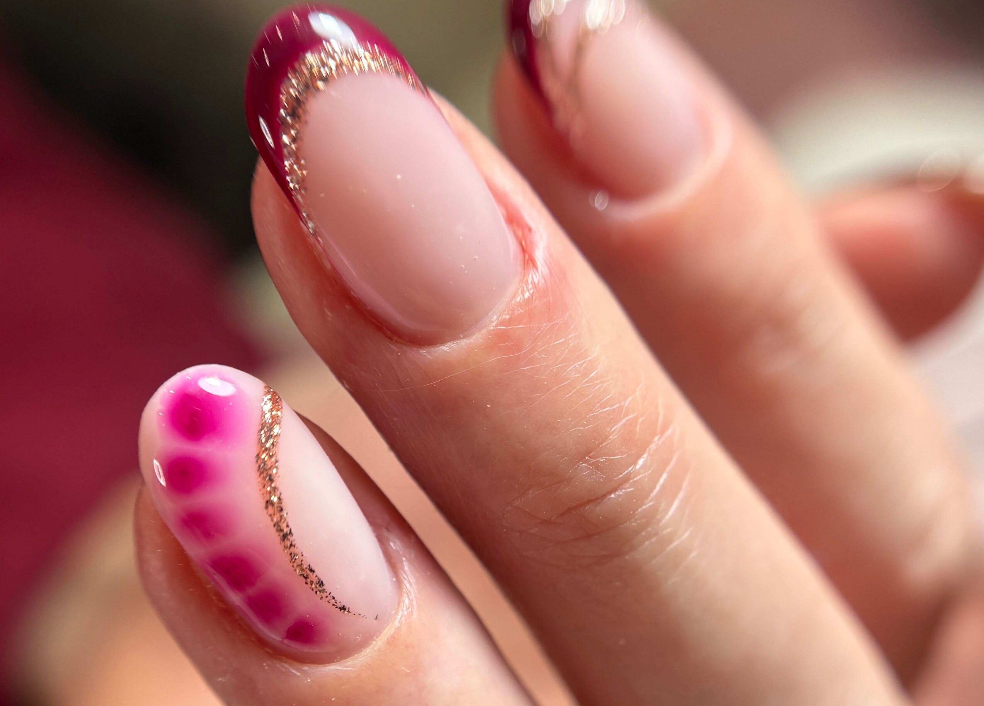 Elegant nail art with gold glitter at Kirsty’s Beauty in Poole, England, GB.