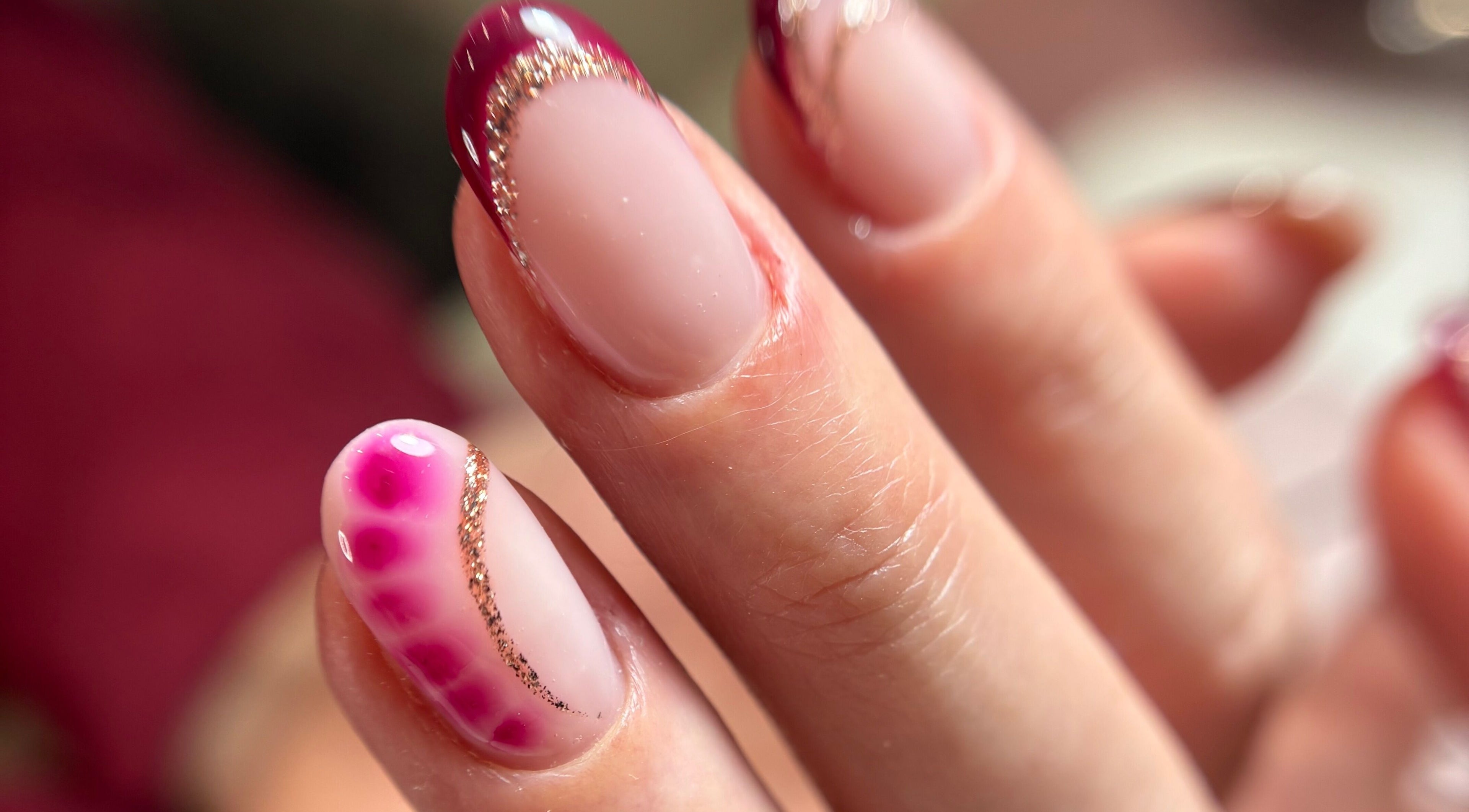 Elegant nail art with gold glitter at Kirsty’s Beauty in Poole, England, GB.