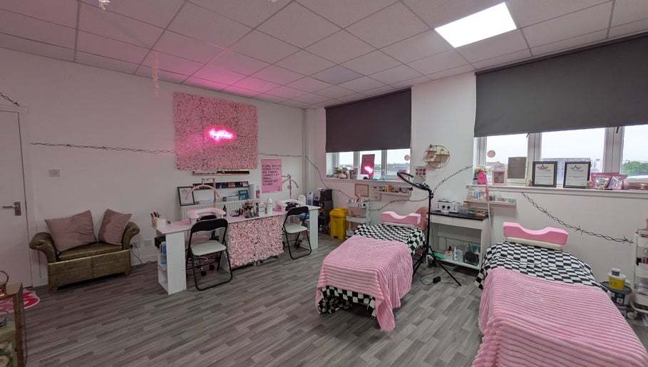 Warm, inviting treatment area at Blossom Beauty and Training Academy, Glasgow, Scotland, GB, with pink decor.