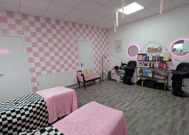 Cozy interior of Blossom Beauty and Training Academy in Glasgow, Scotland, GB, featuring pink decor and mirrors.