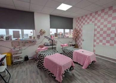 Cozy treatment room at Blossom Beauty and Training Academy, Glasgow, Scotland, GB, with pink decor and treatment beds.