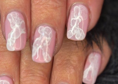 Elegant pink nails with white cloud designs at JNT Nails, Invercargill, Southland, NZ.