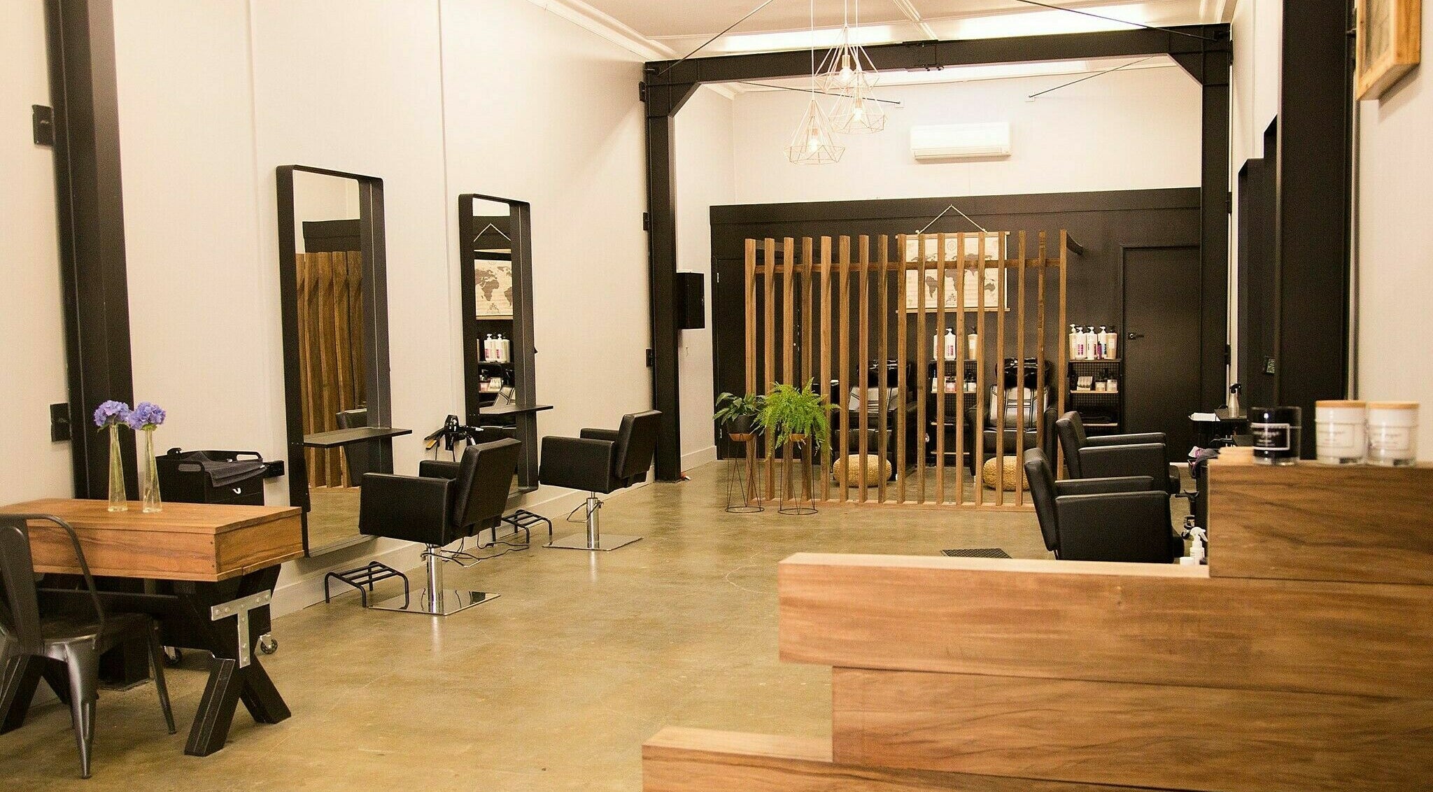 Modern interior of Muse Hair and Beauty in Stratford, Taranaki, NZ with sleek chairs and elegant decor.