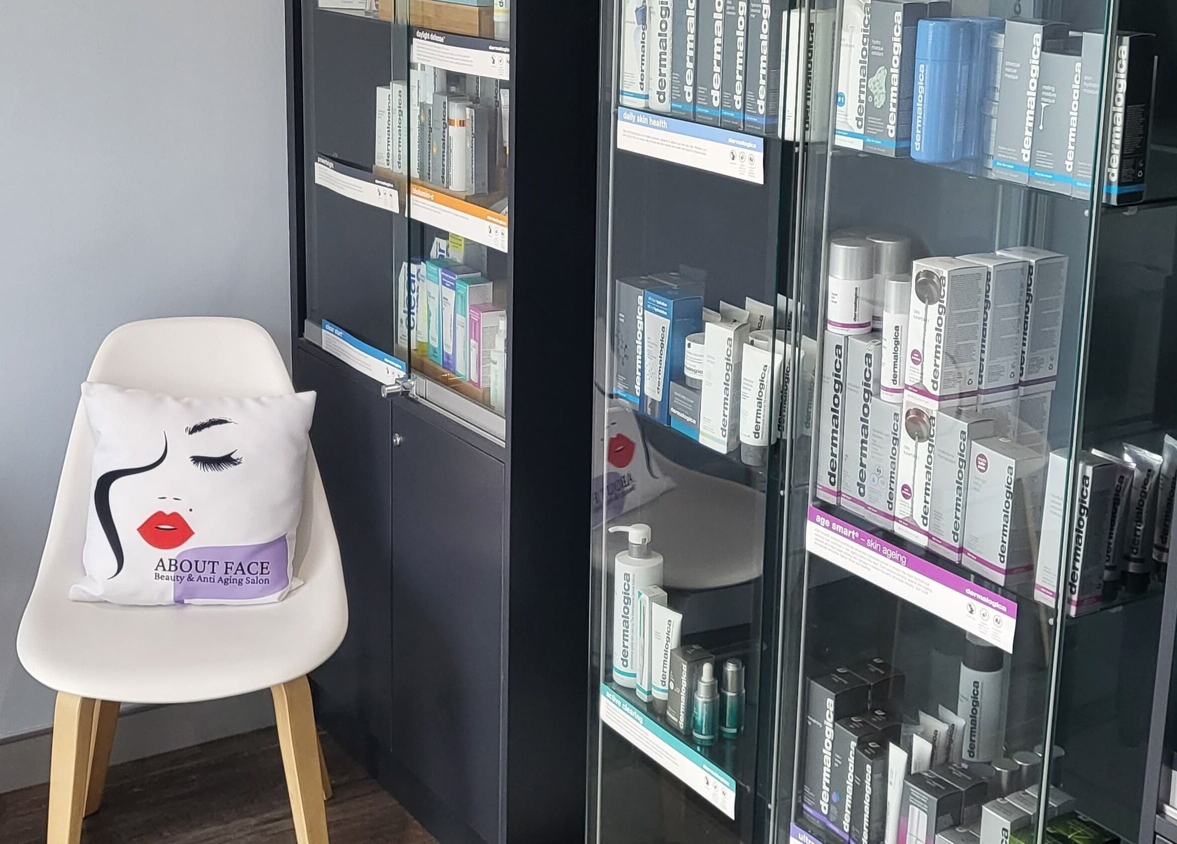 ABOUT FACE Beauty & Anti Aging Salon in Greenway, ACT, AU displays skincare products in a sleek glass cabinet.