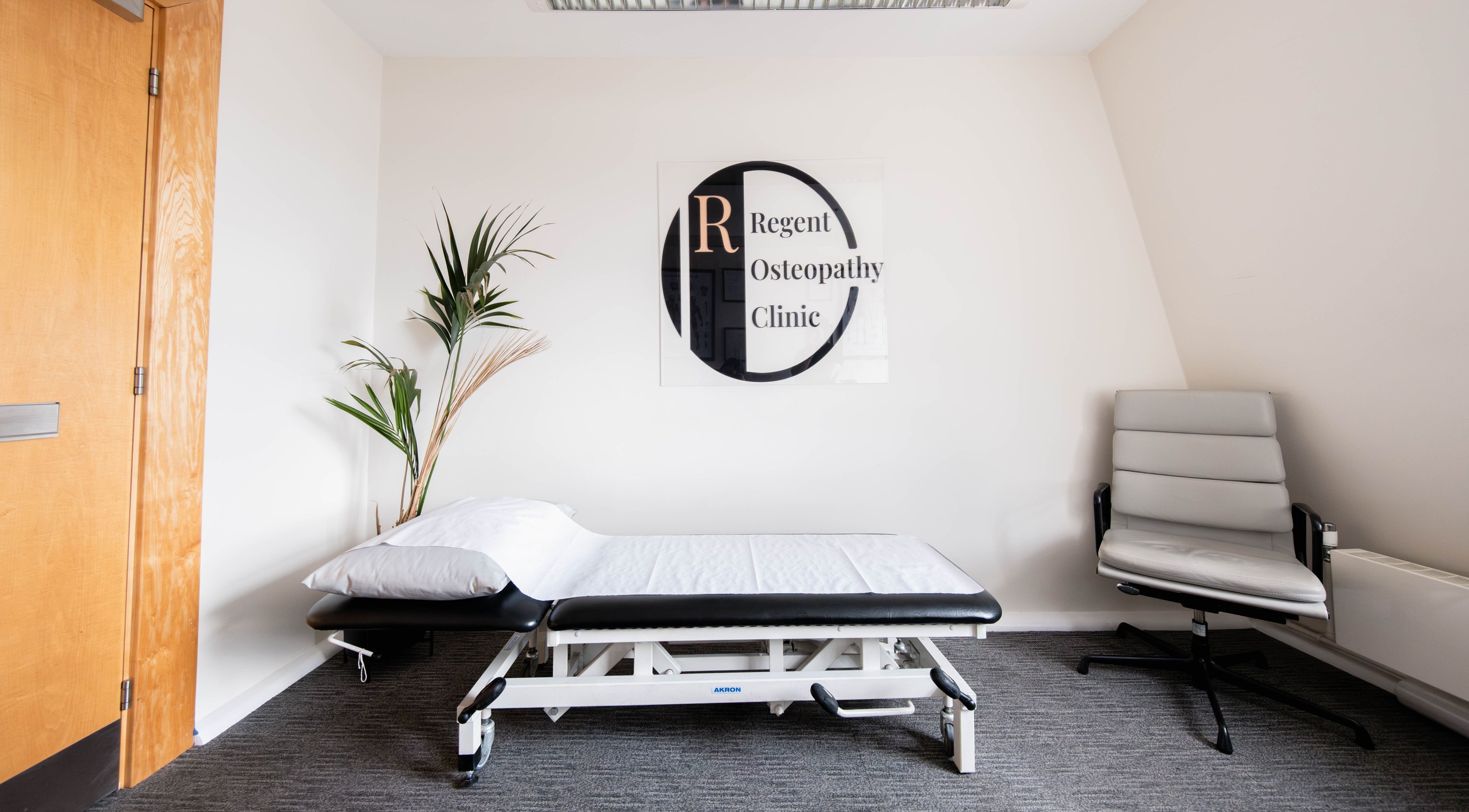 Therapy room at Regent Osteopathy Clinic, London, England, GB, featuring a treatment bed and chair.