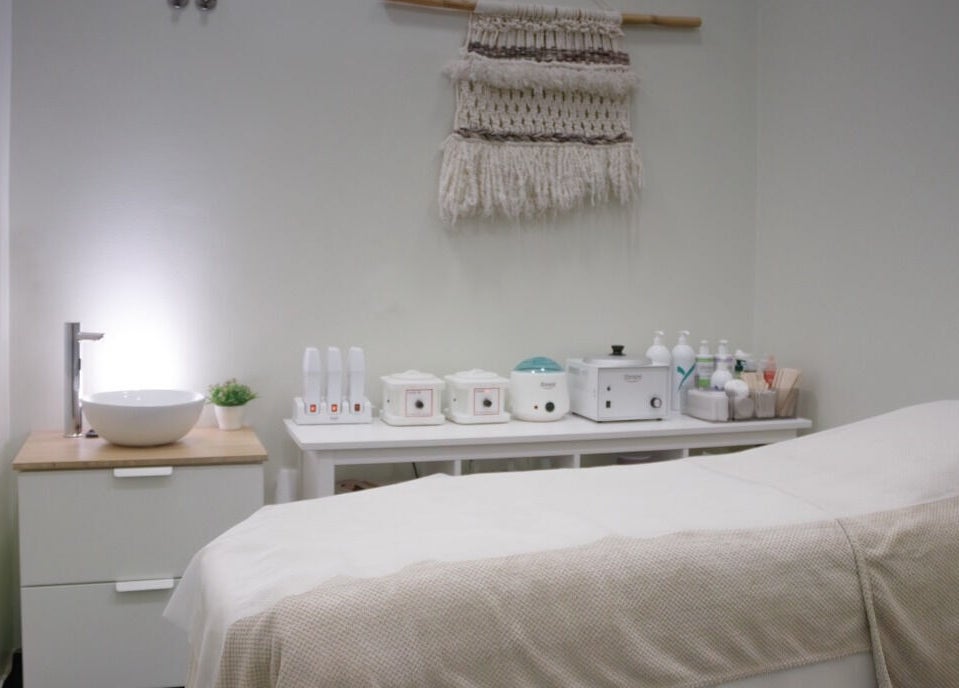 Serene treatment room at Wax Lab Lisbon in Lisboa, Lisboa, PT with modern decor and spa essentials.