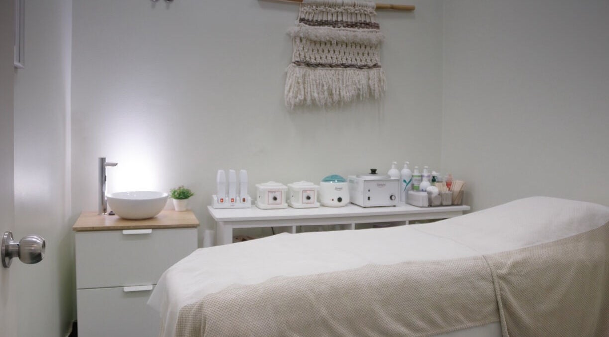 Serene treatment room at Wax Lab Lisbon in Lisboa, Lisboa, PT with modern decor and spa essentials.