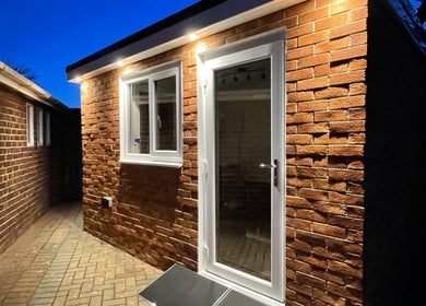 Cozy brick exterior of Sarah and the Hair, Durham, England, GB, glowing warmly at twilight.
