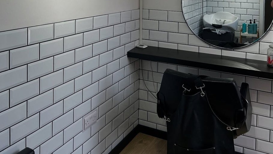 Modern hair styling area at Sarah and the Hair, Durham, England, GB with subway tiles and mirror.