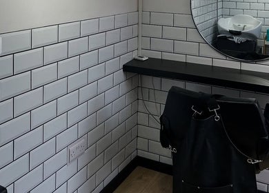 Modern hair styling area at Sarah and the Hair, Durham, England, GB with subway tiles and mirror.