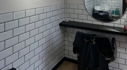 Modern hair styling area at Sarah and the Hair, Durham, England, GB with subway tiles and mirror.