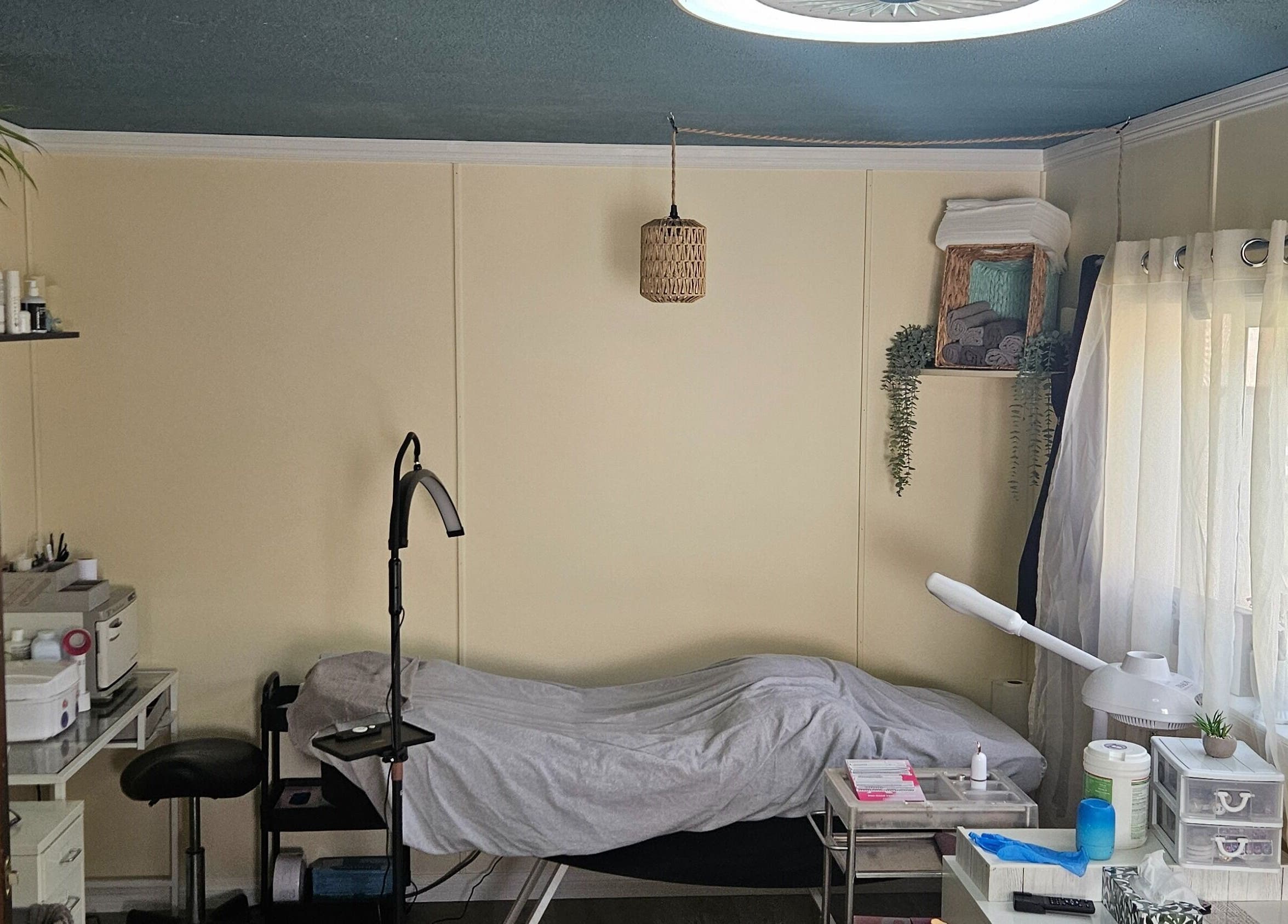 Relaxing treatment room at Manifested Beauty, Rocky Mountain House, Alberta, CA with cozy setup and soft lighting.