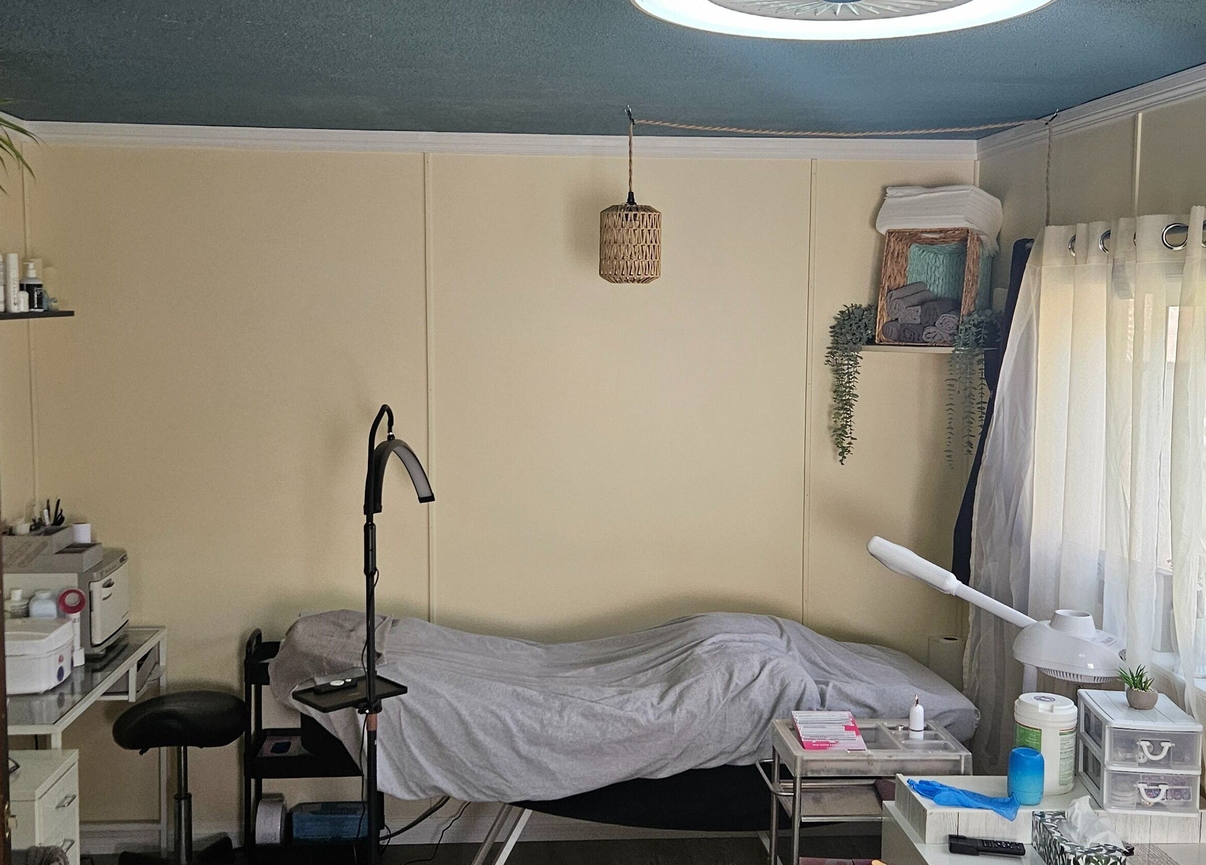 Relaxing treatment room at Manifested Beauty, Rocky Mountain House, Alberta, CA with cozy setup and soft lighting.
