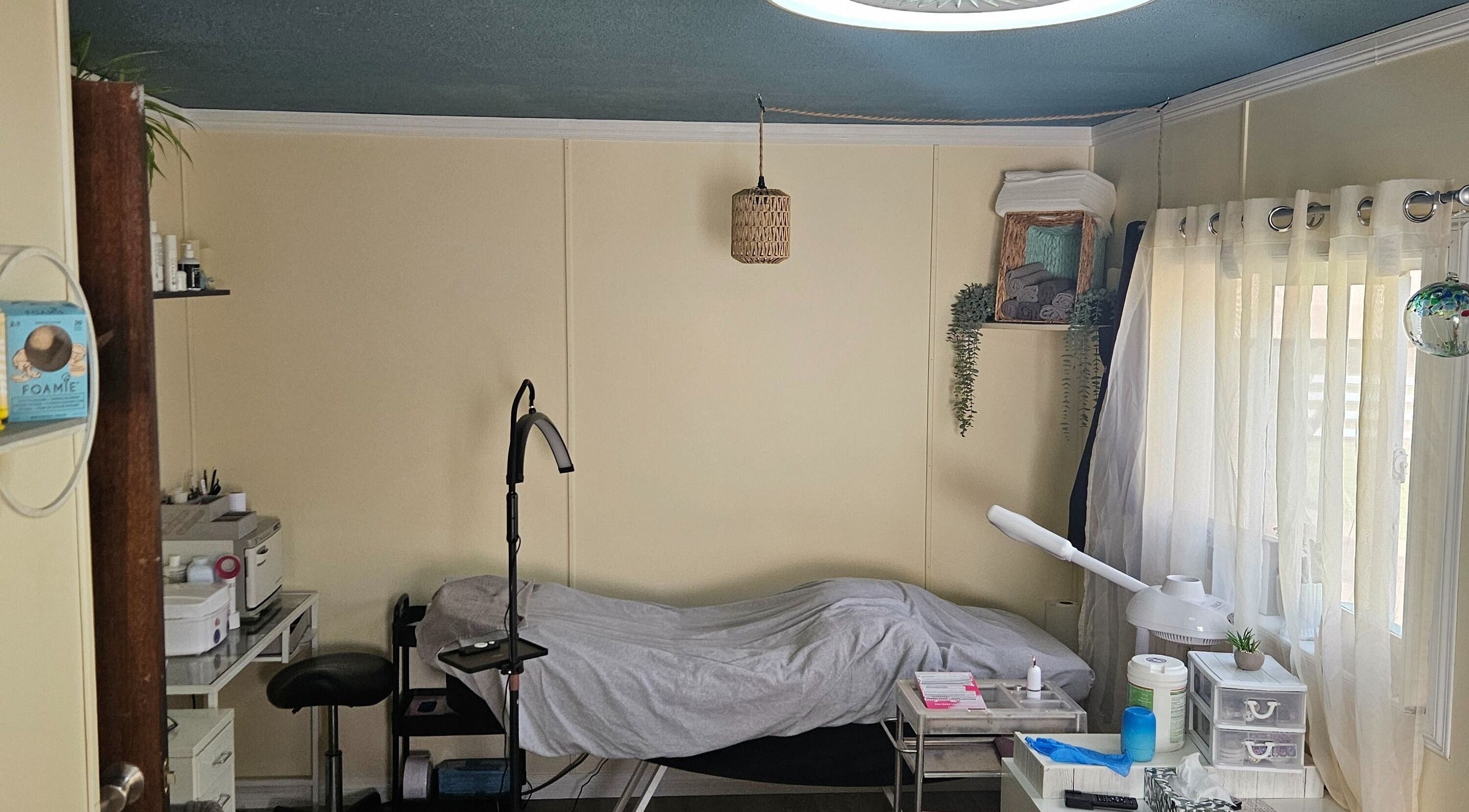 Relaxing treatment room at Manifested Beauty, Rocky Mountain House, Alberta, CA with cozy setup and soft lighting.