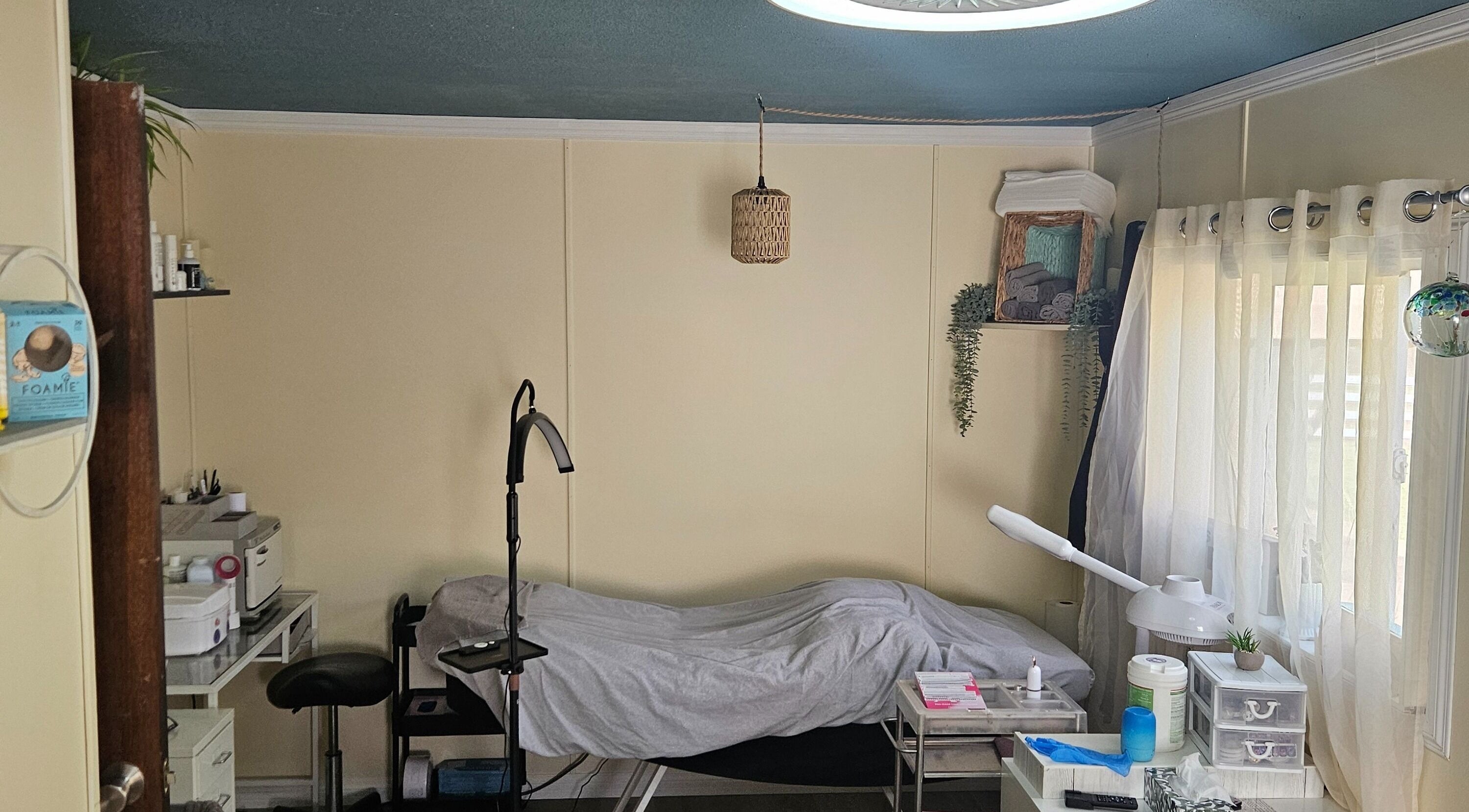 Relaxing treatment room at Manifested Beauty, Rocky Mountain House, Alberta, CA with cozy setup and soft lighting.