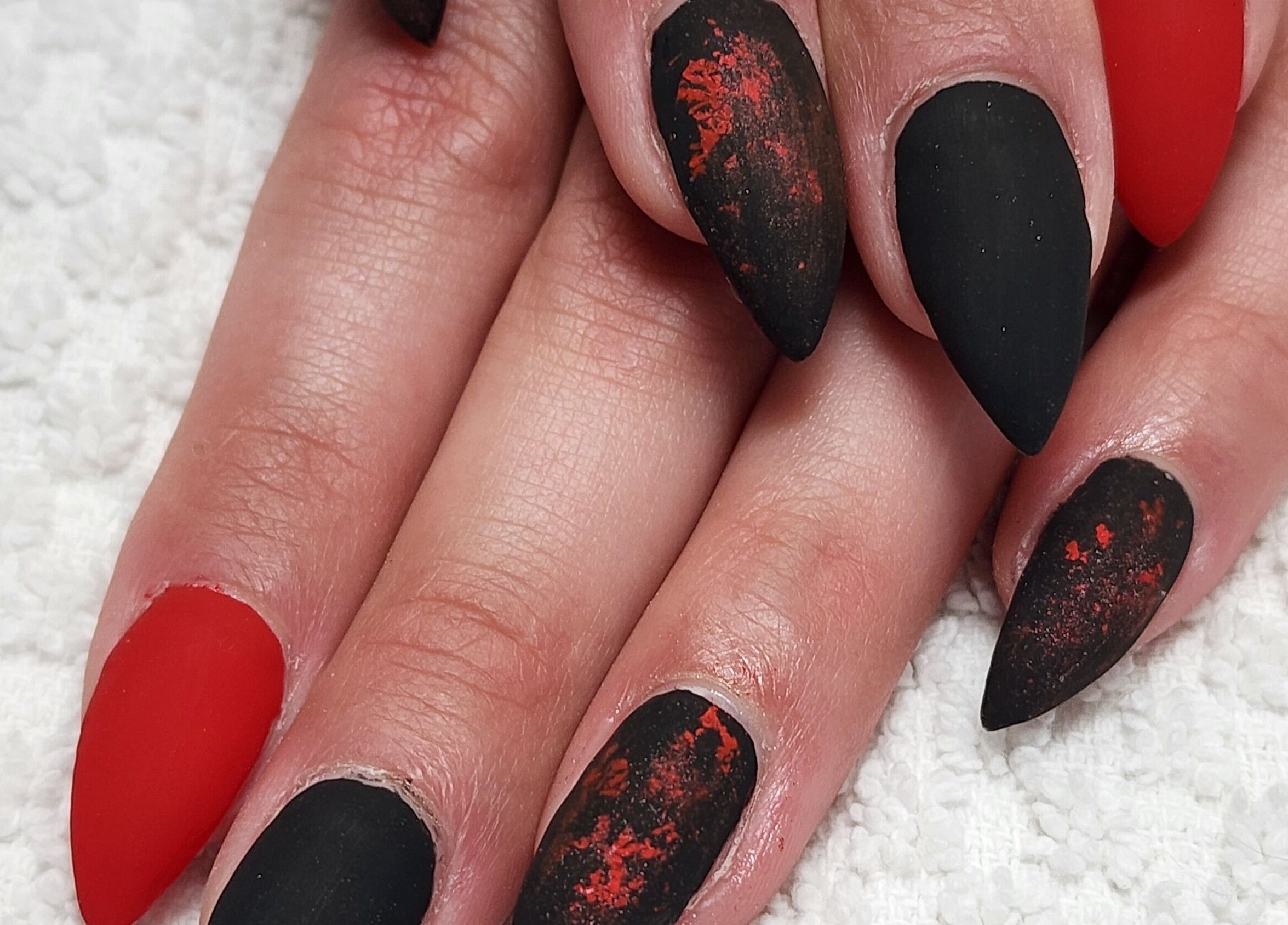 Elegant black and red stiletto nails at Manifested Beauty, Rocky Mountain House, Alberta, CA.