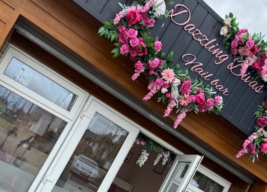 Charming entrance of Dazzling Diva Nails in Athenry, IE, adorned with vibrant floral decor.