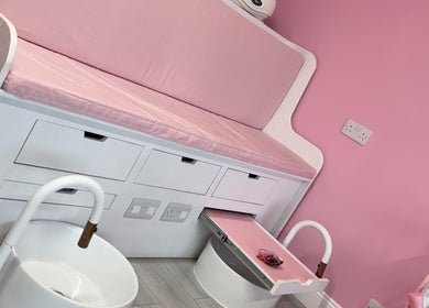 Cozy pink pedicure station at Dazzling Diva Nails in Athenry, IE, featuring plush seating and chic decor.