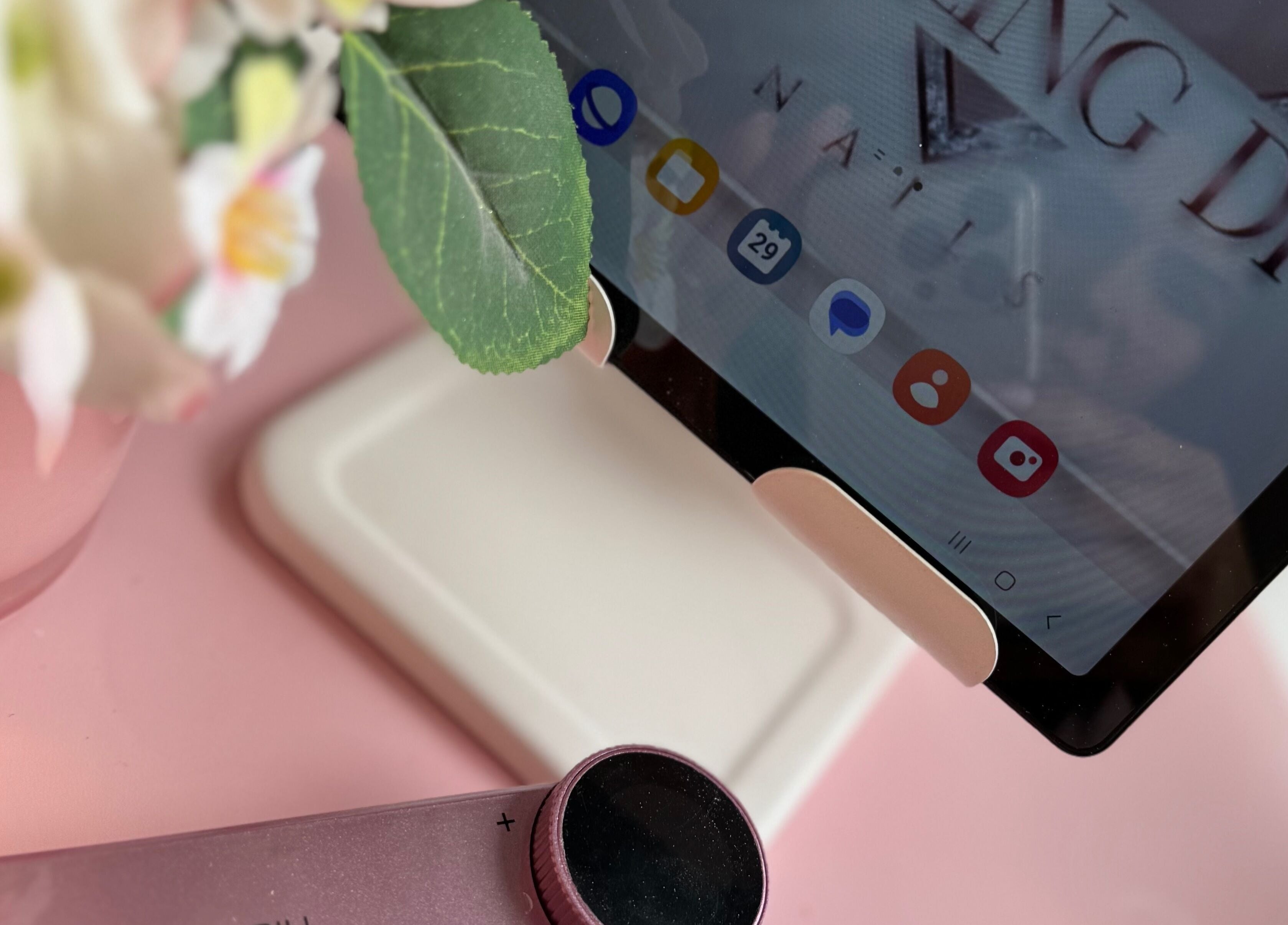 Tablet showing Dazzling Diva Nails' app interface in Athenry, IE, with flowers nearby.