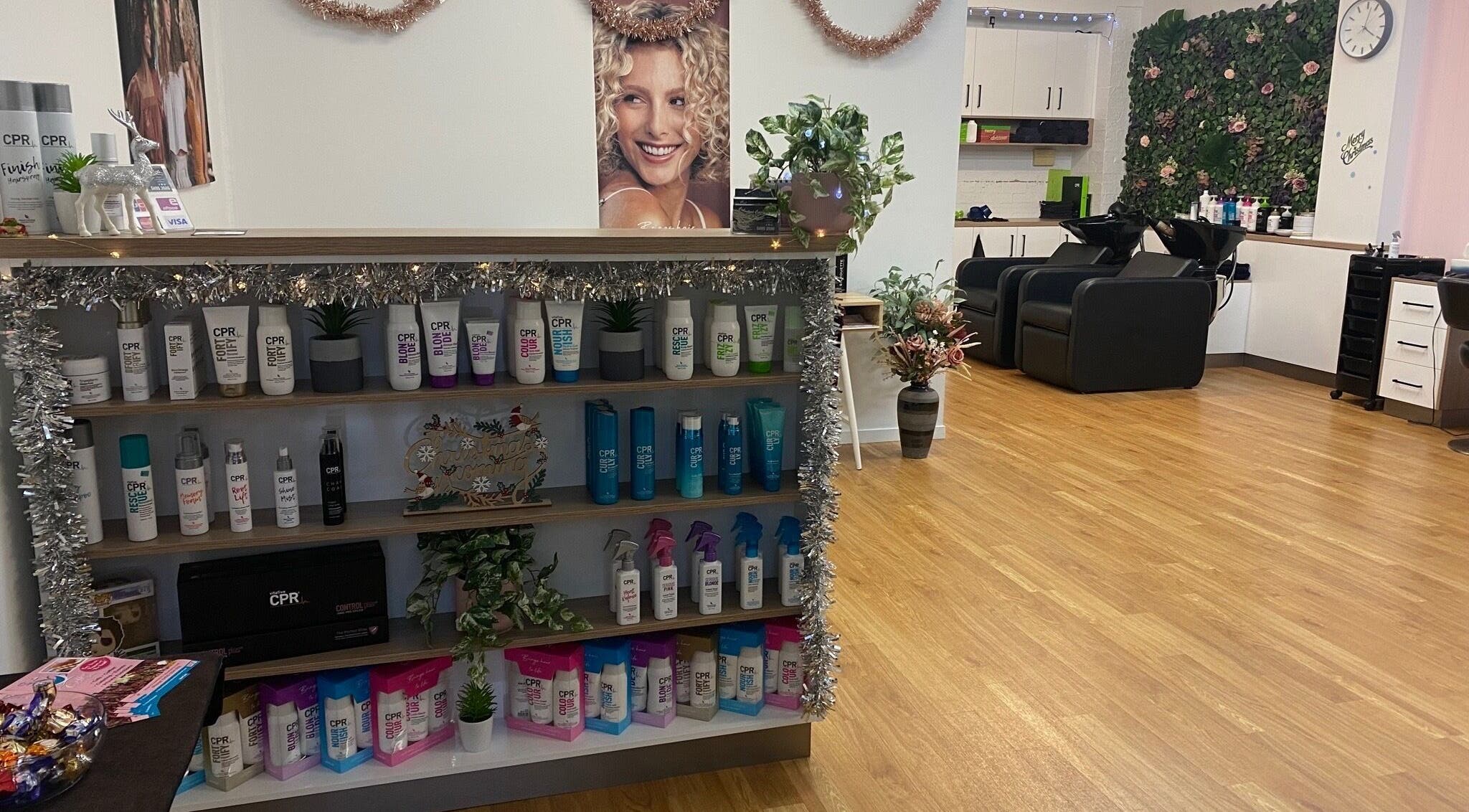 Chic interior of Caboolture Cuts & Curls in Caboolture, Queensland, AU showcasing product display and seating.