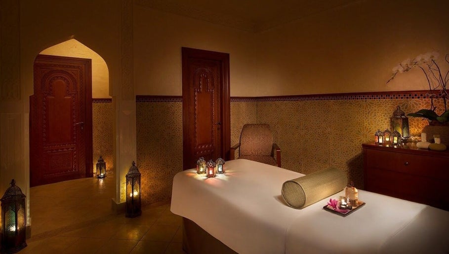 Relaxing spa room at Naturelife Spa - Al Mairid, Ras Al-khaimah, AE with candles and massage table.
