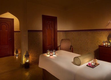 Relaxing spa room at Naturelife Spa - Al Mairid, Ras Al-khaimah, AE with candles and massage table.