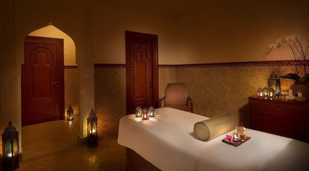 Relaxing spa room at Naturelife Spa - Al Mairid, Ras Al-khaimah, AE with candles and massage table.