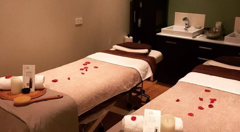 Relaxing spa room at Bonita Day Spa and Beauty, Melbourne, Victoria, AU, with massage tables and rose petals.