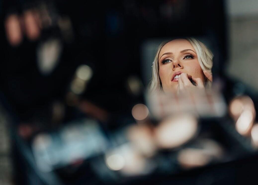 Reflection of a client getting lipstick applied at Rachael Hunter Makeup, East Kilbride, Scotland, GB.