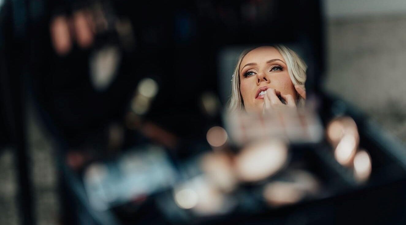 Reflection of a client getting lipstick applied at Rachael Hunter Makeup, East Kilbride, Scotland, GB.
