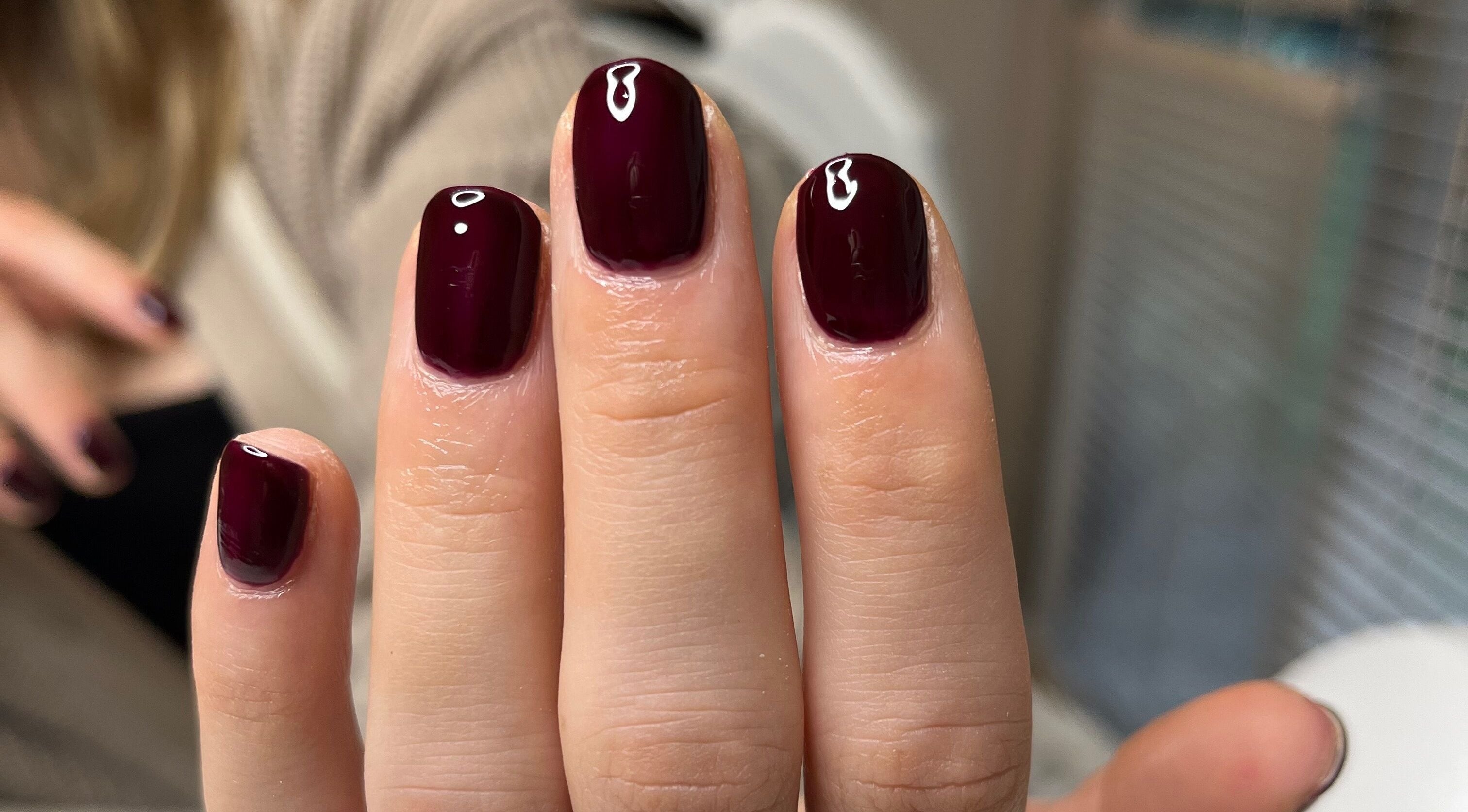 Burgundy manicure at BC Beauty & Aesthetics, Kings Langley, England, GB. Glossy finish exemplifies luxury.