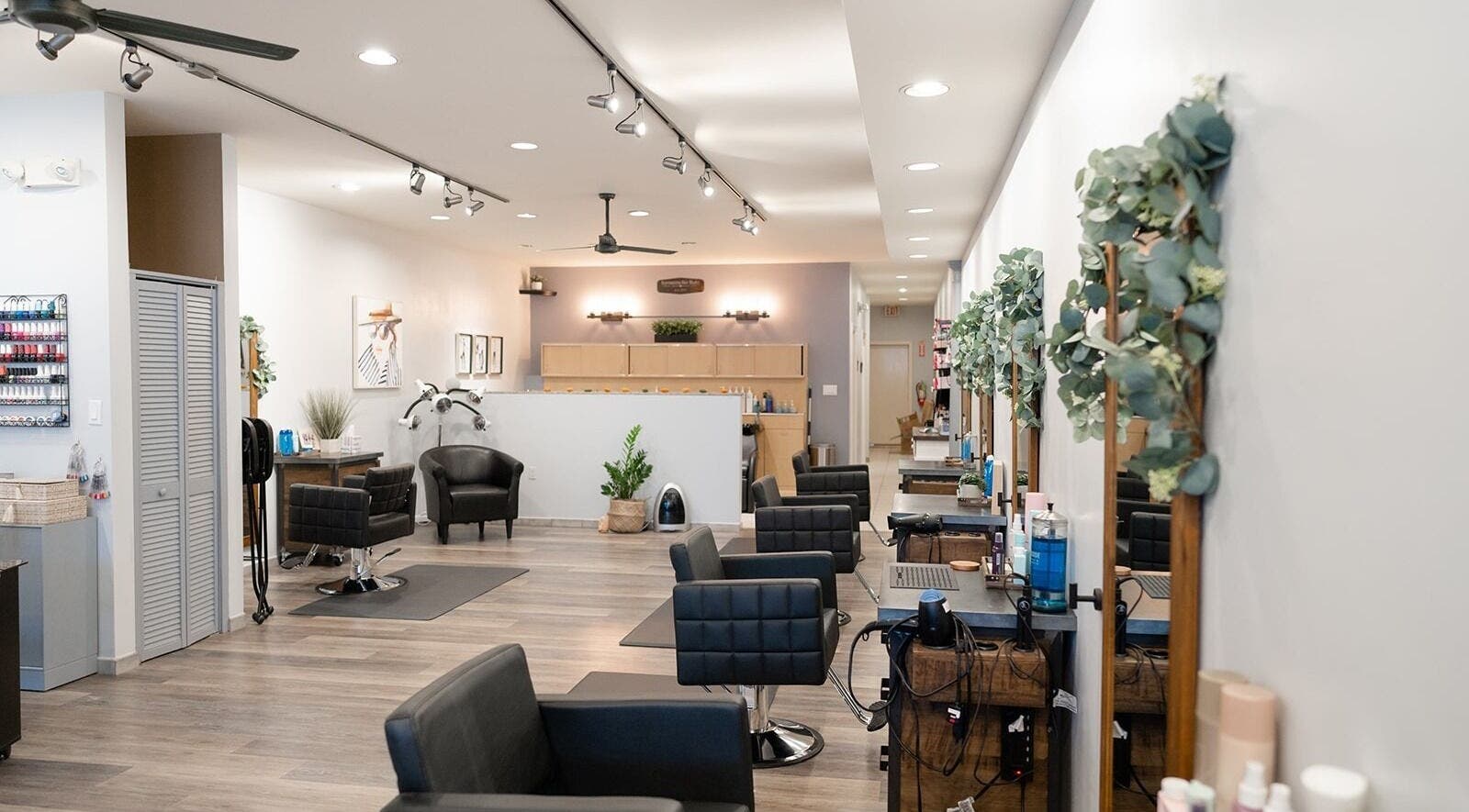 Interior view of Expressions Hair Studio in Reading, Massachusetts, US, featuring stylish black salon chairs.